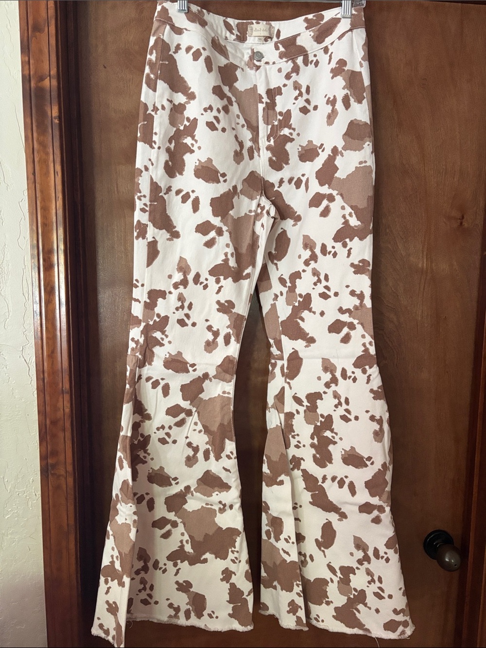 Altar'd State Brown and White Cow Print Flared Leg Jeans
